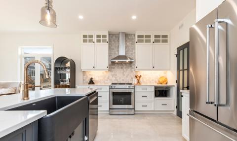 A bright and open kitchen with stainless steel appliances.
